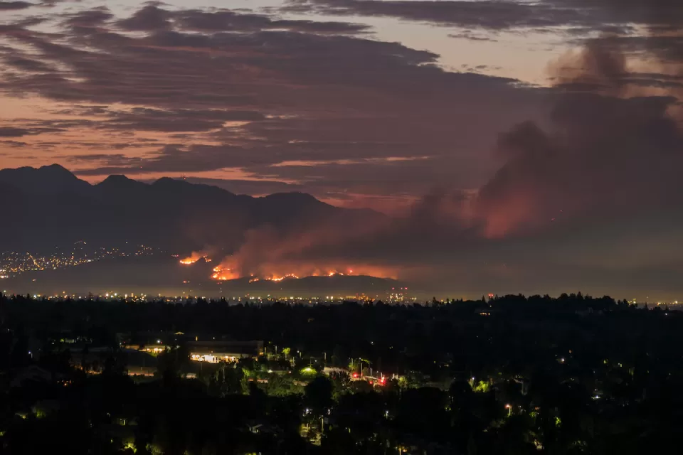 Nighttime view of wildfire in Los Angeles hills.